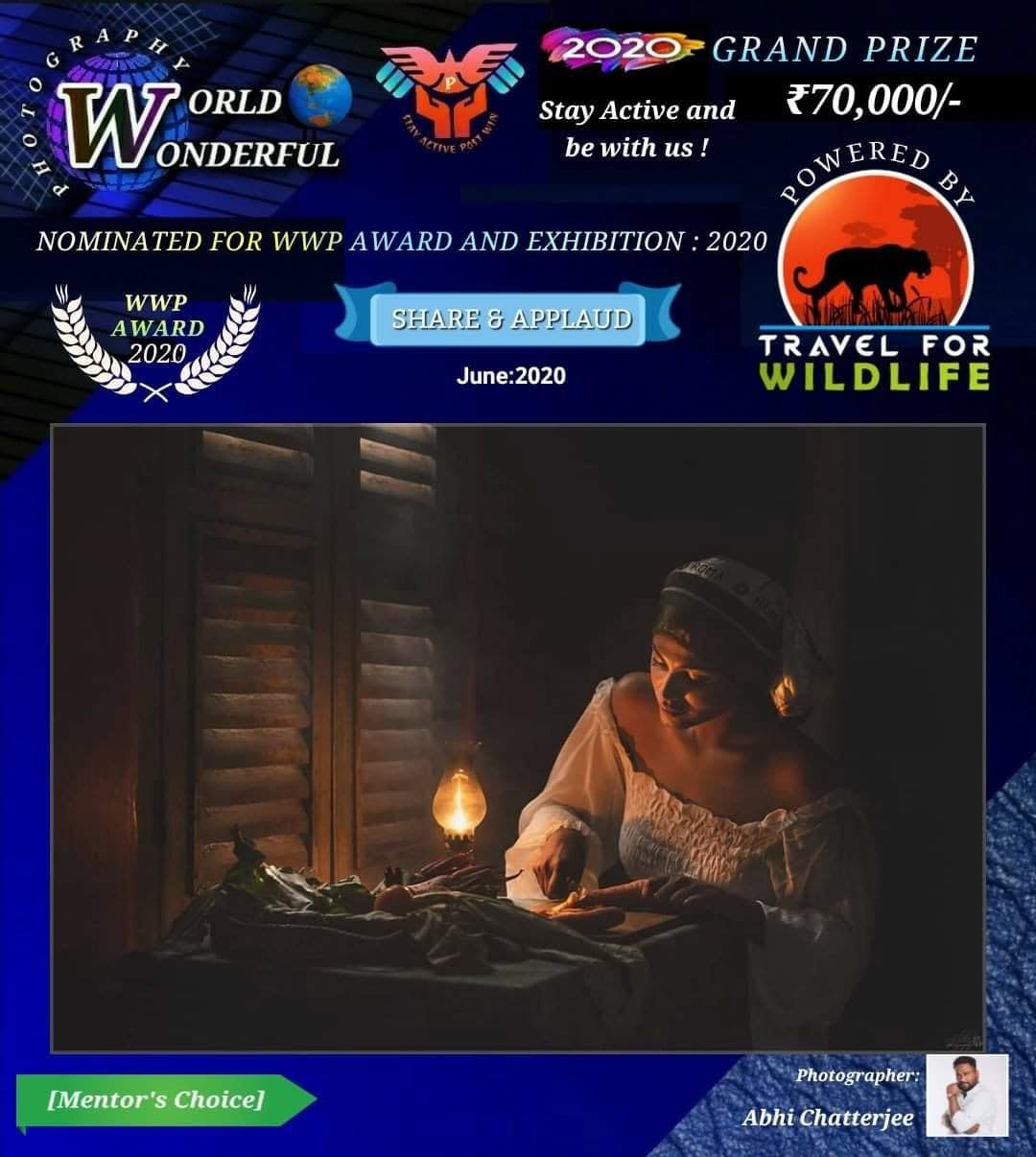 A World Wonderful Photography poster marked Mentor's Choice, showing a woman writing at a wooden table by an oil lamp.