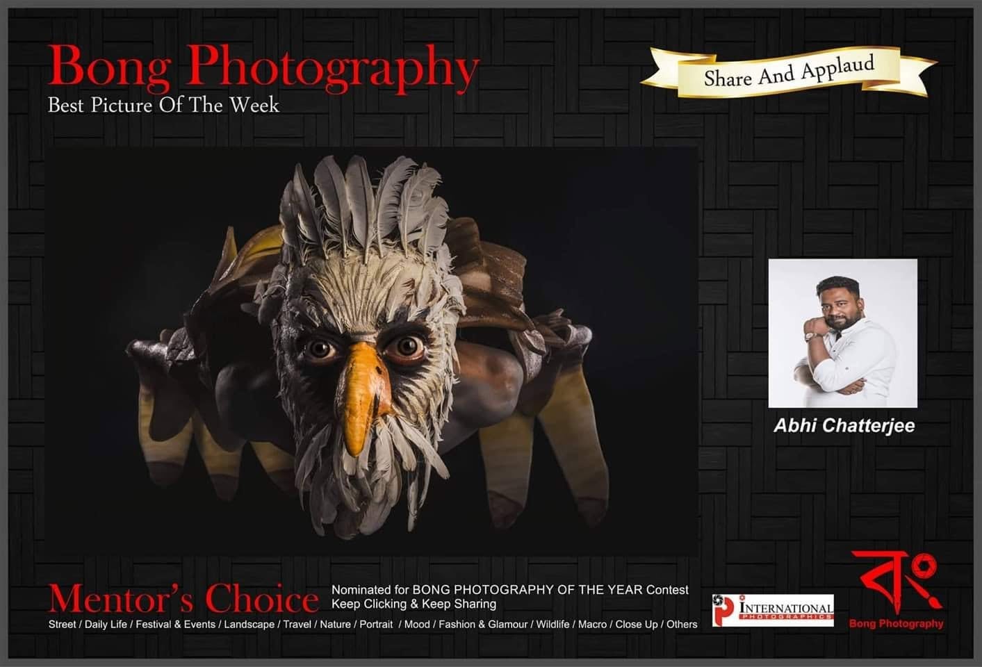 A Bong Photography poster naming the picture of the week, showing a sculpted eagle mask.