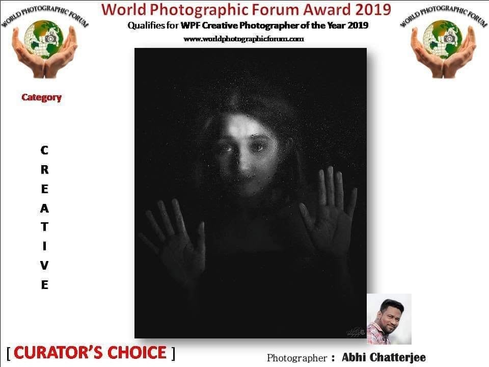 A World Photographic Forum poster marked Curator's Choice, showing hands pressed against frosted glass.